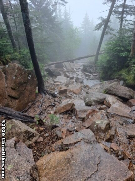 photo of rocky hiking trail in the fog
