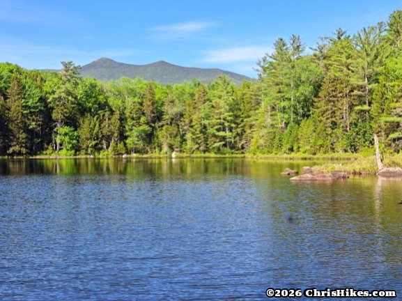 distant mountains viewed across a pond
