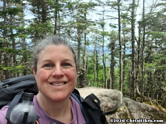 Photo of woman with trees in background