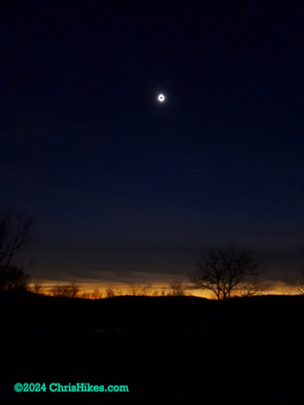 Total eclipse with orange horizon