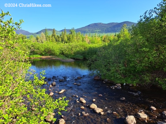 View of Bigelow mountain range across a stream.