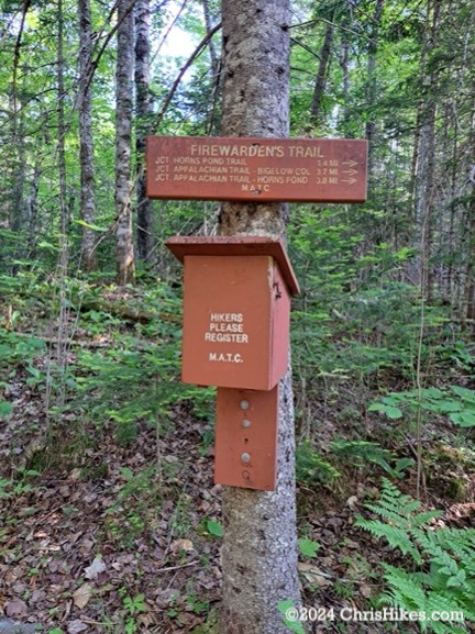 Hiker registration box mounted on a tree.