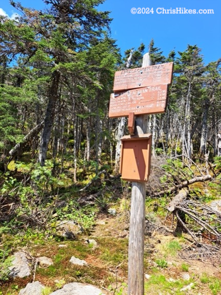 Trail junction sign on a post