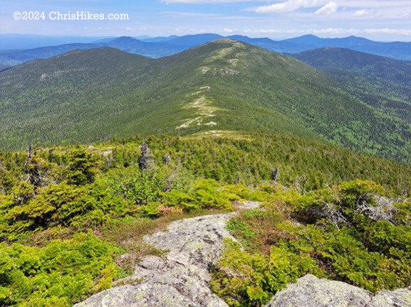 Photograph looking down a mountain trail toward the next mountain