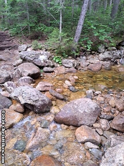 photograph of hiking trail crossing a stream over rocks