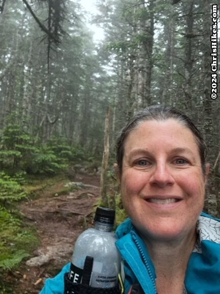 photograph of woman in the woods on a hiking trail