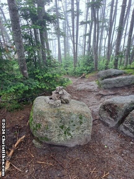 photograph of rock cairn on top of a boulder