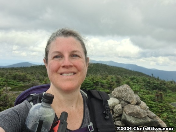 photograph of woman on a mountain summit