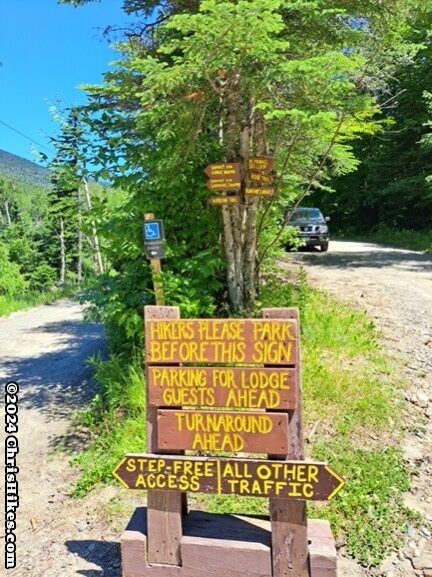 stack of brown signs with yell letters placed in the Y of a road