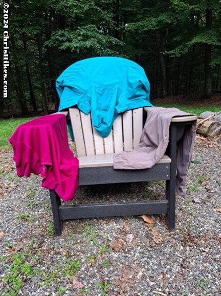 photograph of clothing hanging over an Adirondack chair